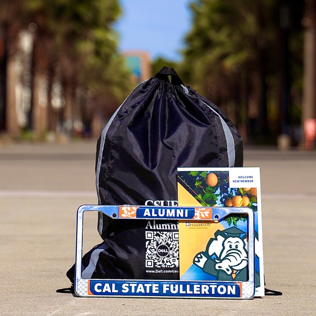 CSUF Alumni Grad pack, license plate, drawstring bag, and folder with info